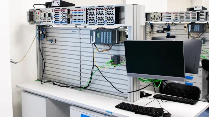 A contemporary office showcasing a server rack and computer workspace, ideal for tech and business settings.