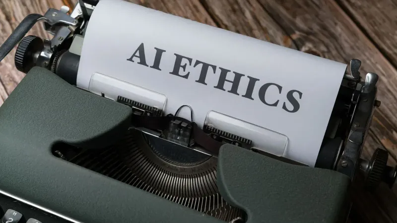 Retro typewriter with 'AI Ethics' on paper, conveying technology themes.