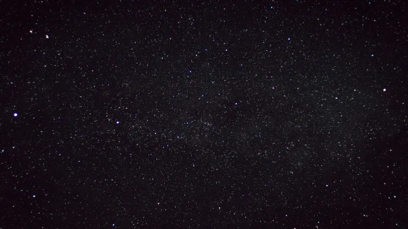 A clear starry night sky captured over the countryside in Germany, showcasing countless stars.