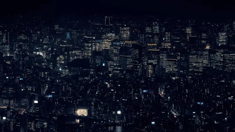 A stunning view of Tokyo's cityscape with illuminated skyscrapers at night, showcasing urban life in Japan.