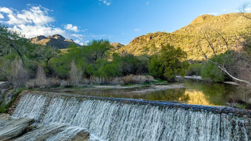 Serene view of Sabino Canyon dam waterfall and mountains in Tucson, Arizona.