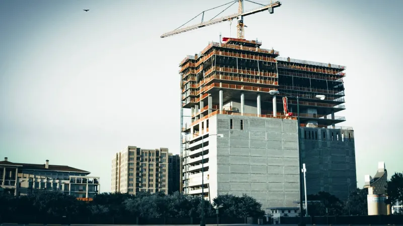 A modern high-rise building under construction in urban Houston, Texas.