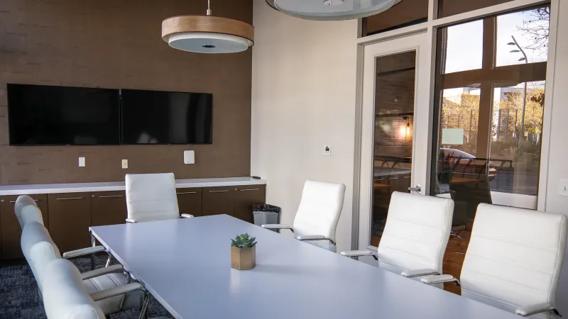 Spacious and modern conference room with sleek furniture and natural lighting.