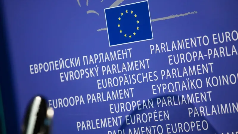 Close-up view of the European Union flag with multilingual text showing European Parliament.