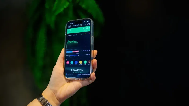 Close-up of a smartphone displaying a stock trading app with market data on-screen.