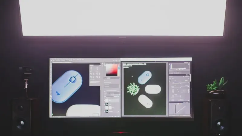 A modern desktop setup featuring dual monitors, keyboard, and mouse, ideal for graphic design.