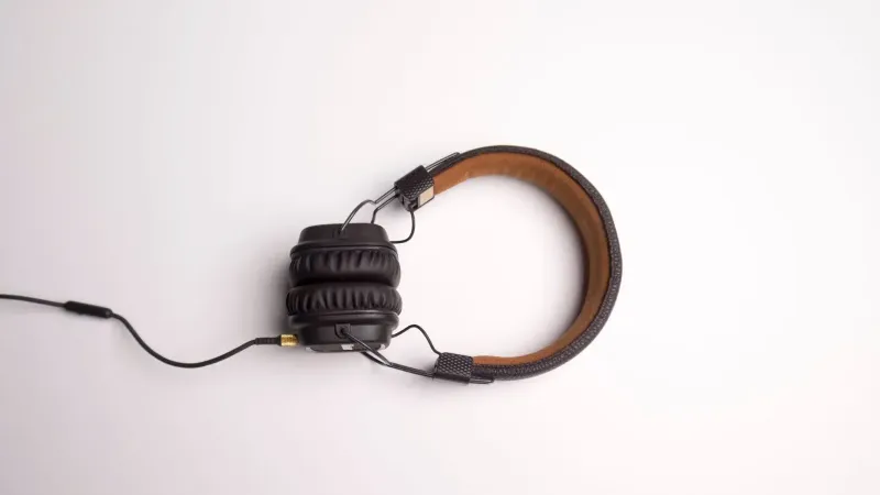 Minimalist image of black over-ear headphones on a white background.