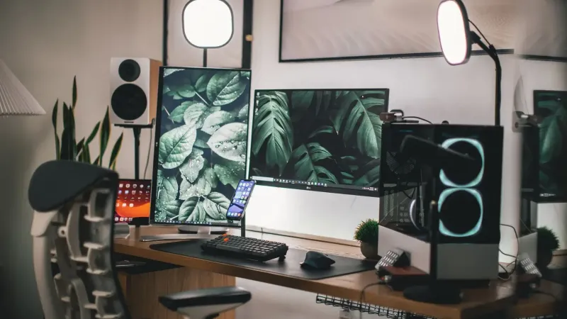 Stylish gaming and streaming setup with dual monitors, PC, and accessories.