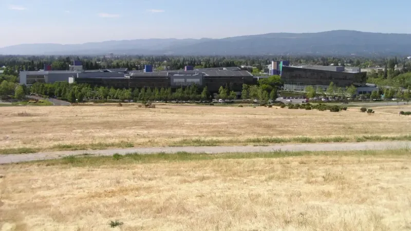 A photo of Google corporate headquarters, taken from across the street looking West.