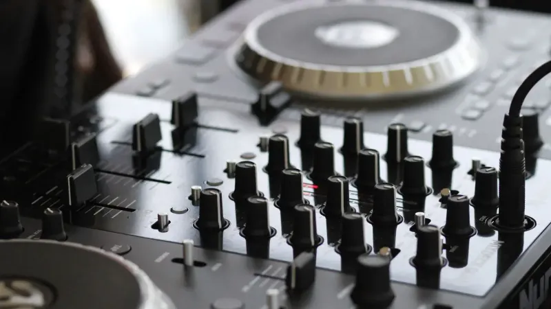 Detailed view of a professional audio mixing console with knobs and controls for sound engineering.