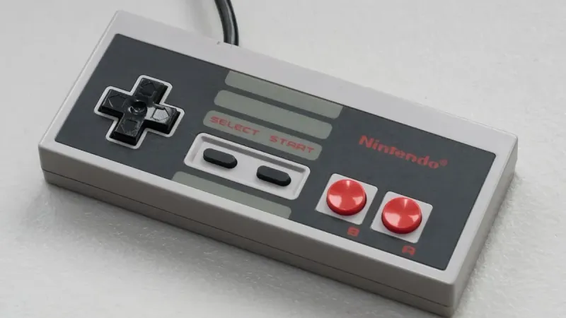 Top view of a vintage Nintendo controller on a white background, emphasizing retro gaming vibes.