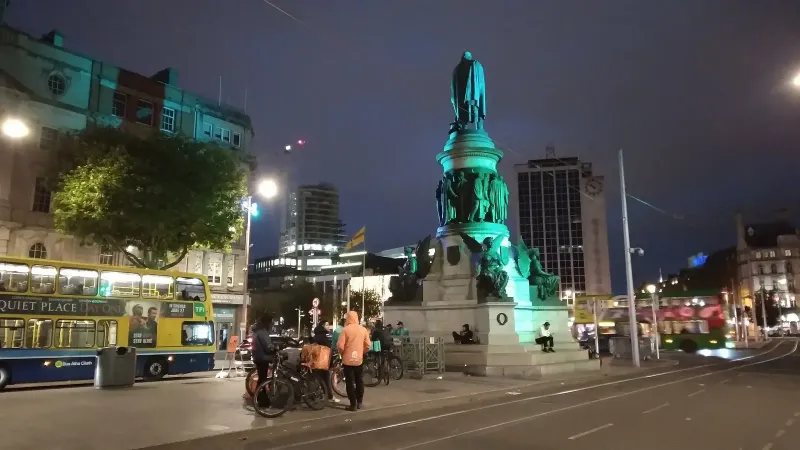 Deliveroo and Just Eat cyclists waiting at the O'Connell Monument for jobs to appear on their app(s).