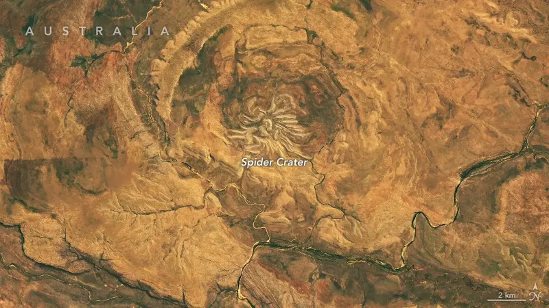 Several short, light-colored rocky ridges radiate out from a central point amid an orange and tan desert landscape.