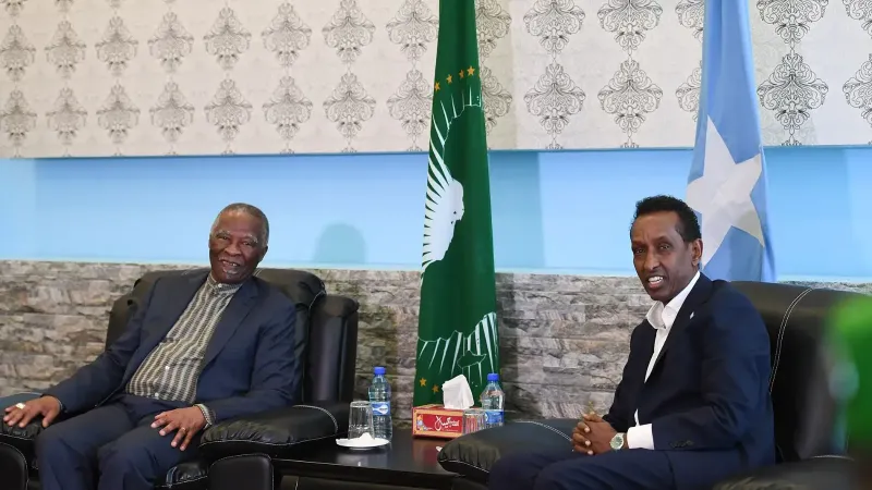 The former President of South Africa, Thabo Mbeki (left), and Somalia's Federal Minister for Foreign Affairs and International Cooperation, Ambassador Ahmed Isse Awad (right), meet in the