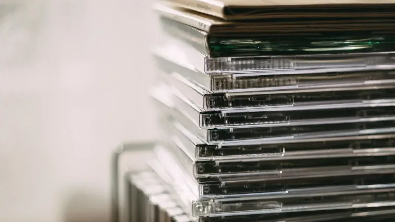 A stack of transparent CD cases neatly aligned, creating a still life composition.