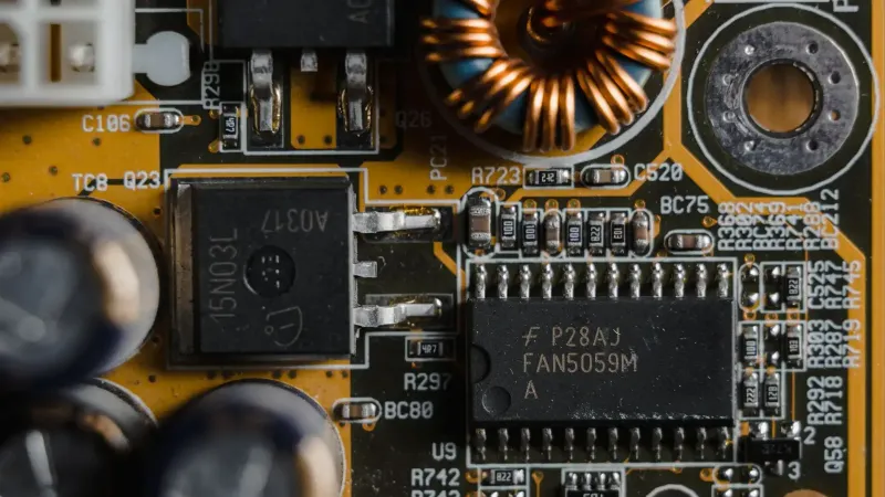 Detailed view of microchips and components on a motherboard circuit board.