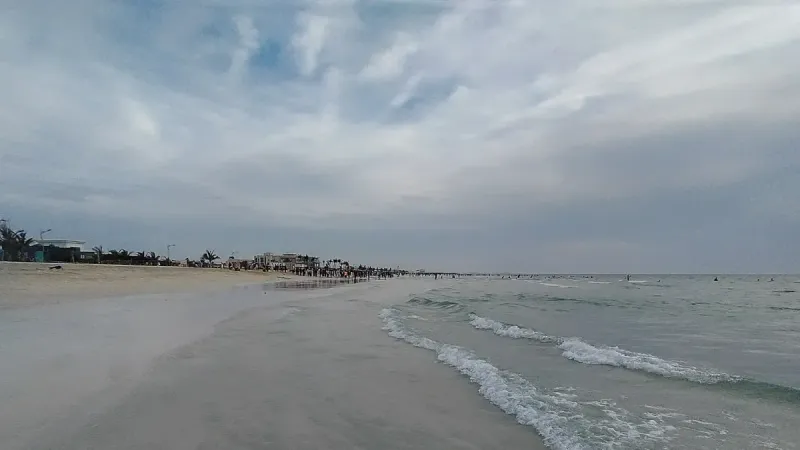 A photo of the Umm Al Quwain beach shores by sunset with the fine sand and clear waters