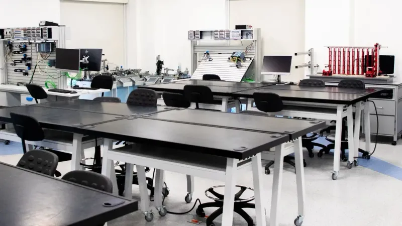 Un aula contemporánea equipada con herramientas y estaciones de trabajo tecnológicas avanzadas.