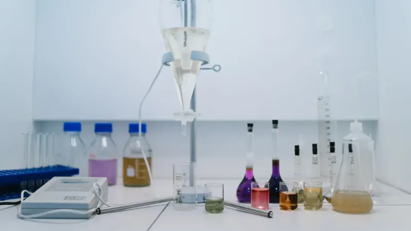 A detailed view of laboratory glassware with colorful chemicals, ideal for scientific research and experiments.