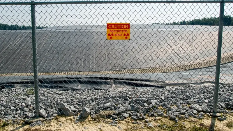 A radiation warning sign on the fence outside the restricted area at the Maxey Flat Low Level Radioactive Waste site in Maxey Flat, Kentucky, USA.