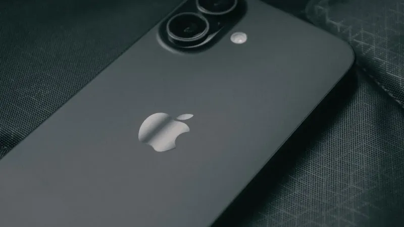 Detailed close-up of a modern smartphone on a textured dark fabric background.