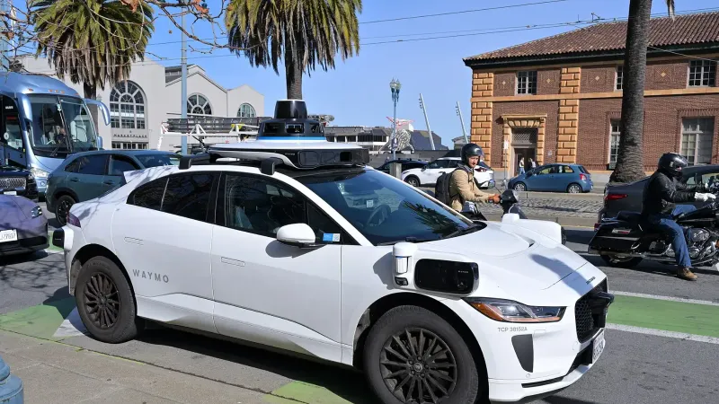 A Waymo Jaguar I-Pace autonomous taxi on the Embarcadero in San Francisco